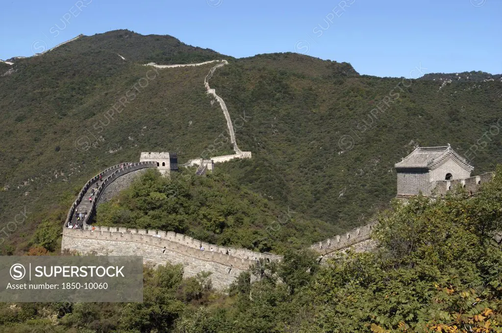 China, Great Wall, View Over A Section Of The Wall Which Leads Through The Green Hilly Landscape