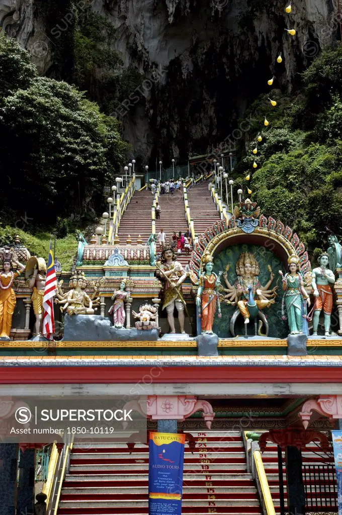 Malaysia, Near Kuala Lumpur, Batu Caves, View Looking Up The Steep Teps Toward The Cave Entrance With Colourful Statues Atop Columned Archway In The Foreground