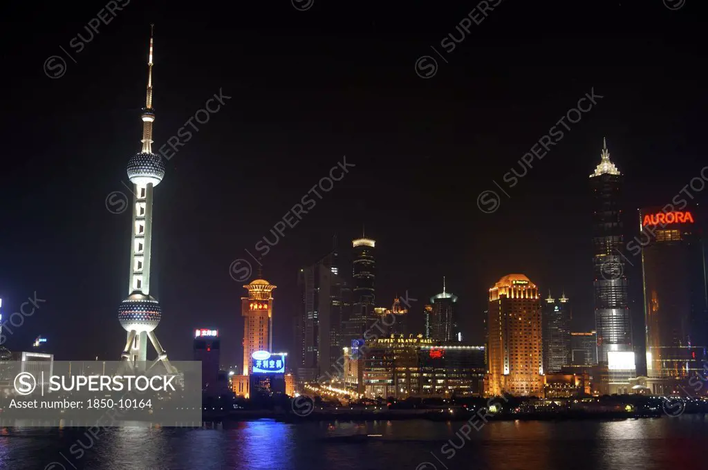China, Shanghai, Waterfront City Skyline And Tv Tower Illuminated At Night