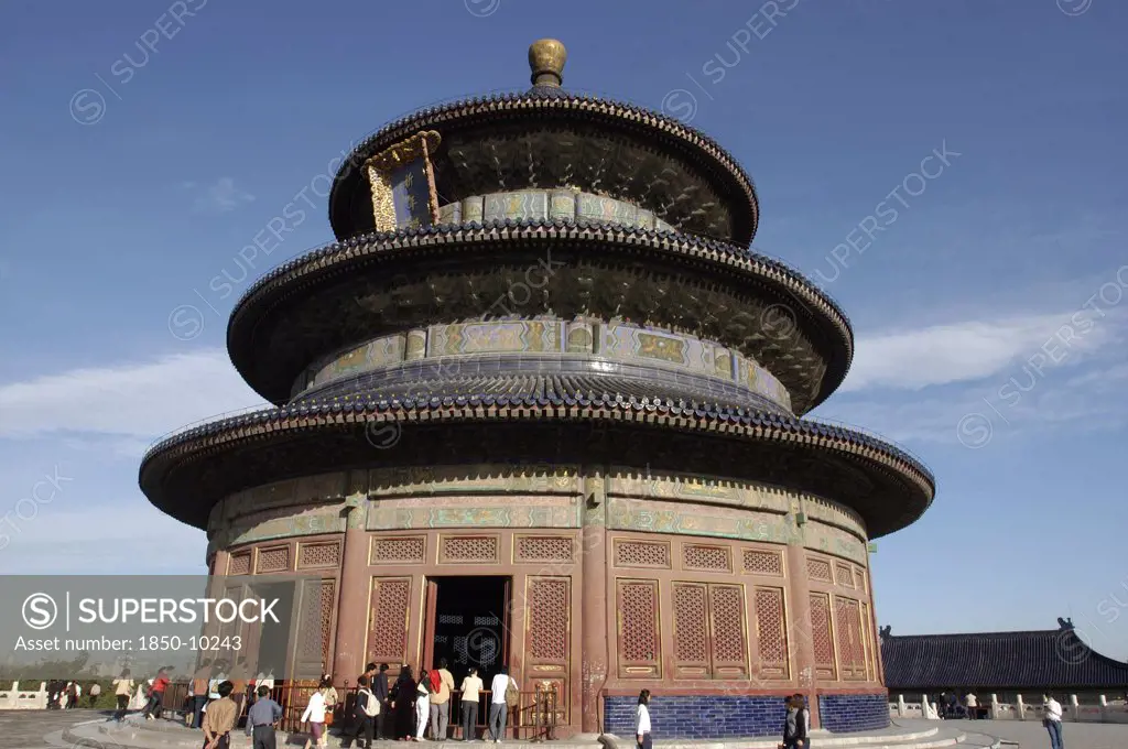 China, Beijing, Tiantan Park, Aka The Temple Of Heaven. View Of The Hall Of Prayer For Good Harvests With People Gathered At The Base
