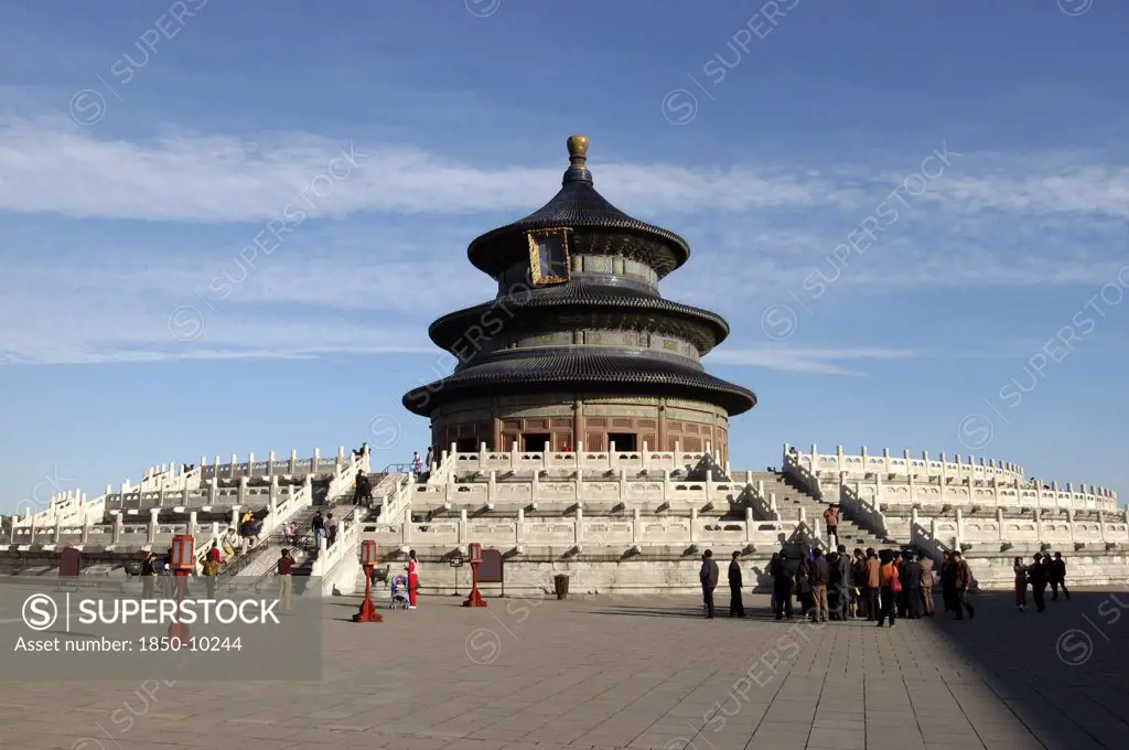China, Beijing, Tiantan Park, Aka The Temple Of Heaven. View Of The Hall Of Prayer For Good Harvests With People Gathered At The Base Of The Steps