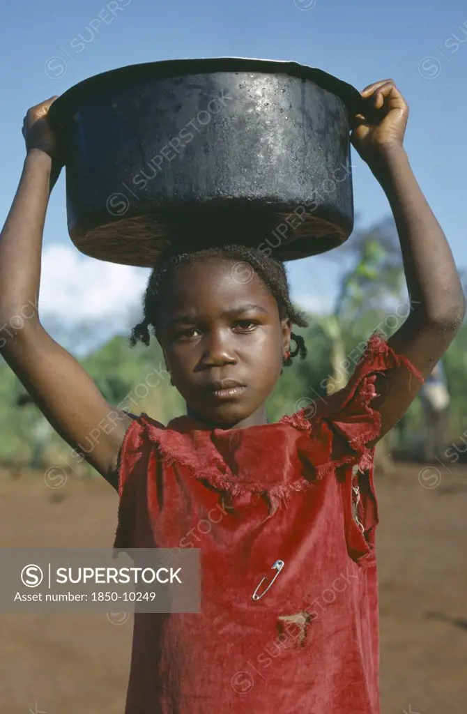 Congo, Tribal Peoples, Young Girl Carrying Water Vessel On Her Head.