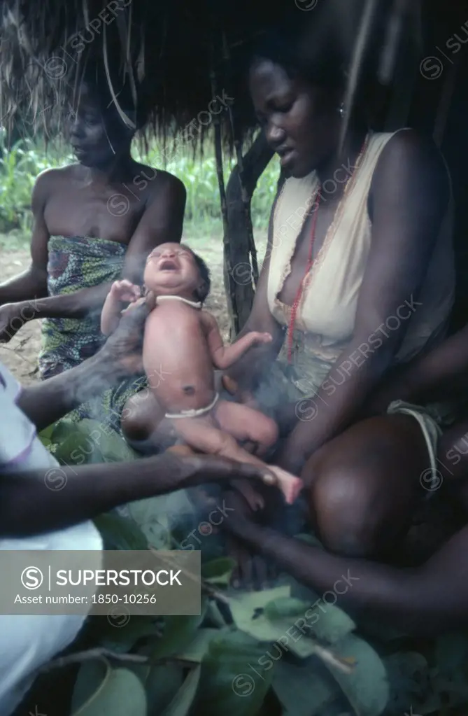 Sudan, People, Azande Women And Child During Ritual Purification Of New Born Baby In Smoke.