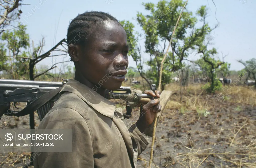 Uganda, North, Portrait Of A Karamojong Tribesmen With An Automatic Weapon Guarding Cattle Near Lira Against Border Raids From The Turkana People Of Kenya