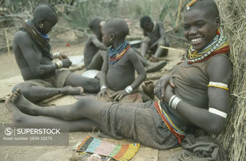 Uganda, Karamoja, Karamojong Girl From The Mathenico Clan Wearing Traditional Bead Jewellery And With Beadwork To Be Worn By Unmarried Girls.