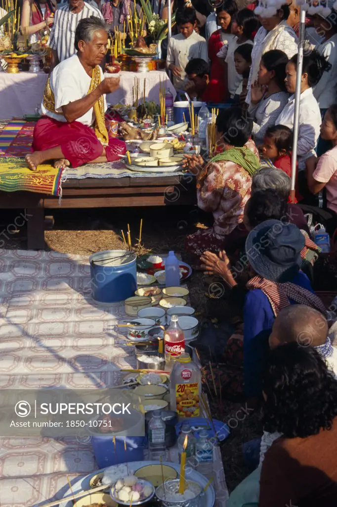 Cambodia, Siem Reap, Angkor Wat, Shaman At Ceremony Smelling The Offerings Of Food Brought By The Khmer People