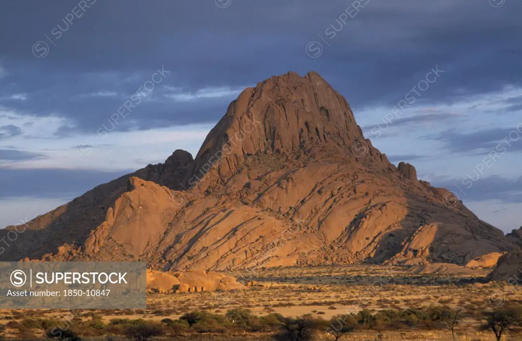 Namibia, Sptitskoppe Mountains, Huge Rocky Outcrop In Barren Landscape