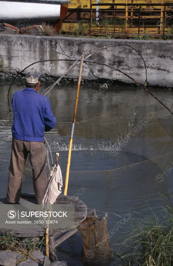 Bulgaria, Burgas, Fisherman With Traditional Hand Held Net