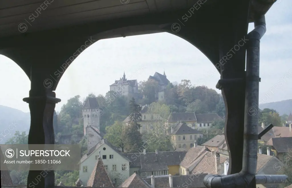 Romania, Transylvania, Mures, Sighisoara.  View Of Town Rooftops Framed By Archway.  Famous As Being The Birthplace Of Vlad Tepes Or Dracula.
