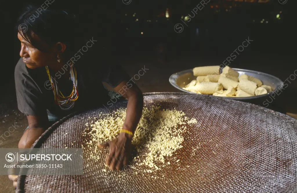 Colombia, Amazonas, Santa Isabel, Macuna Woman Sieving Manioc That Has Previously Been Grated Washed And Pressed.