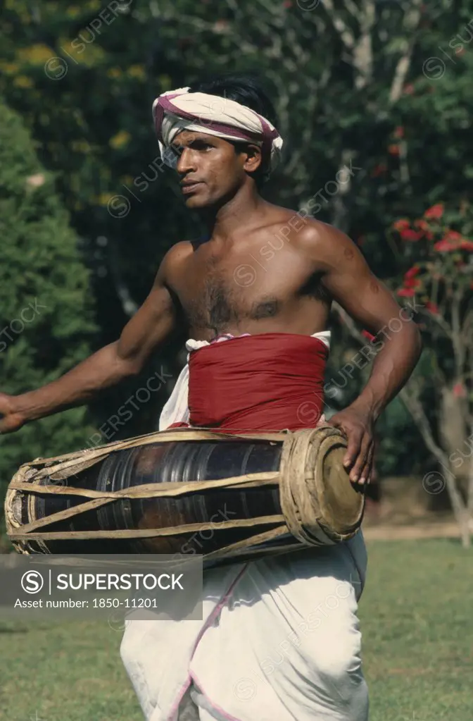 Sri Lanka, Kandy, Perahera Buddhist Festival.  Traditional Drummer.