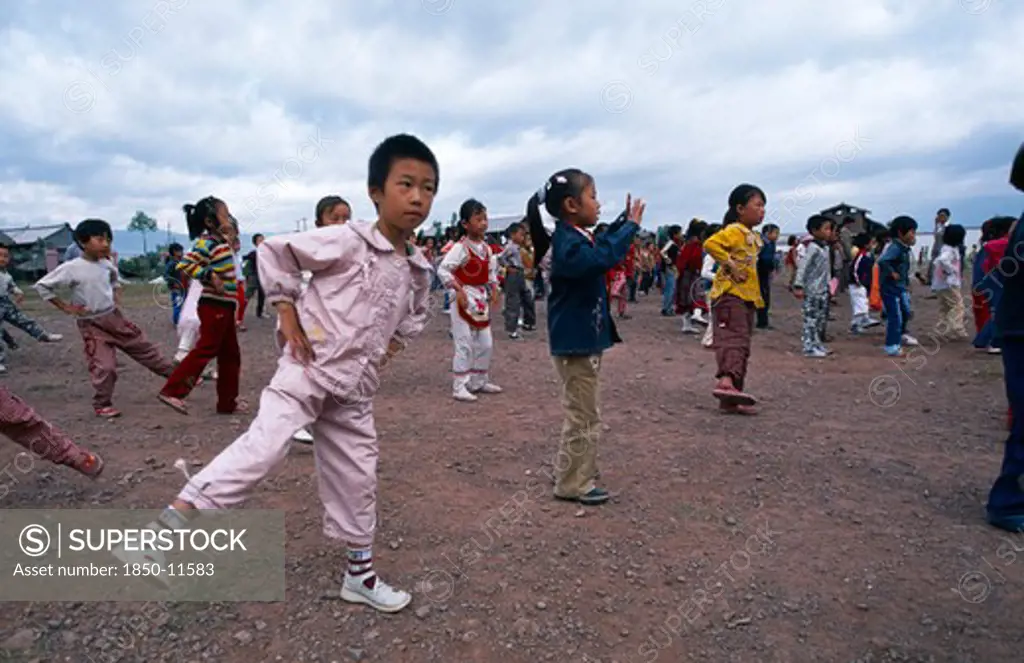 China, Yunnan Province, Children Taking In Part In Formation Exercising Outside Of Their School.