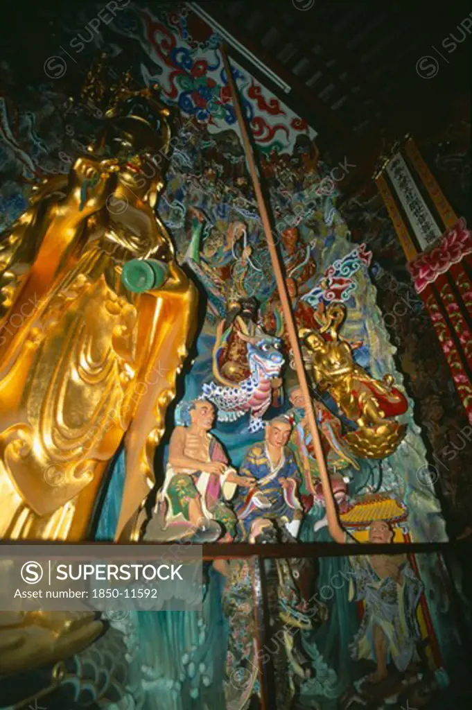 China, Yunnan, Kunming, Golden Statuary Inside Huating Temple.