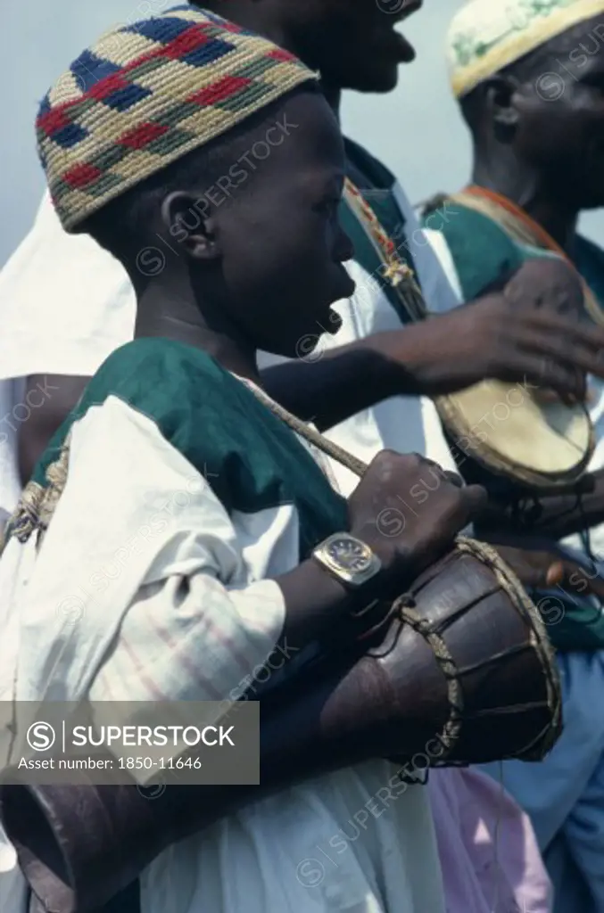 Nigeria, Music, Child Musician Playing Bongo Drums.