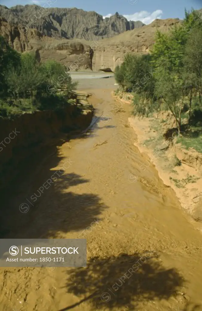 China, Yellow River , View Over Rapid Flowing Silt Laden Water Toward Main River