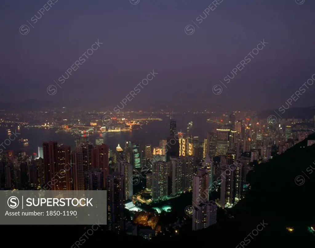 Hong Kong, Victoria Peak   , Elevated View Over The Harbour Illuminated At Night With Skyscrapers And The Bank Of China