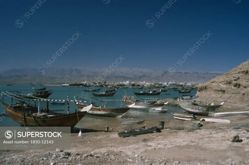 Oman, Sur, Boats Moored Along Coastline.