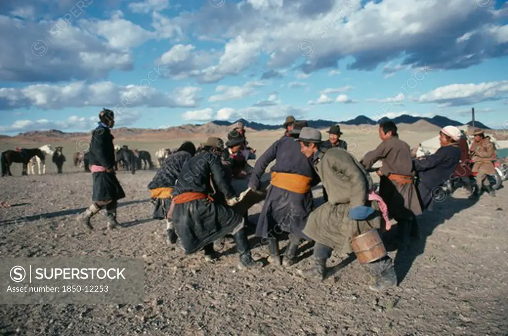 Mongolia, Southern Gobi, Men Stretching Felt For A Yurt As Part Of A Traditional Wedding Ceremony.
