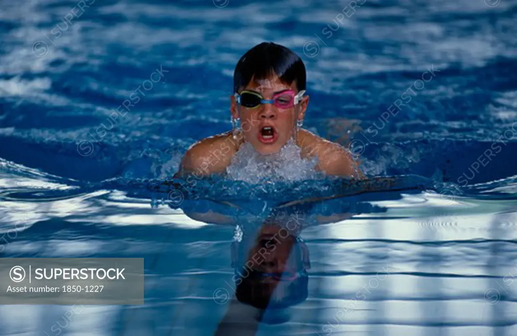 Sport, Watersport, Swimming, Boy Wearing Swimming Goggles Doing Breaststroke In Indoor Pool.