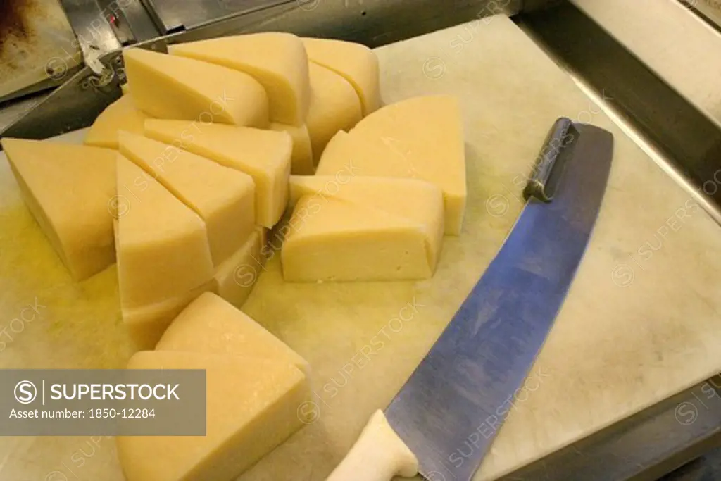 Usa, Minnesota, St Paul, 'Wedges Of Freshly Cut Park Brand Parmesan Cheese From Wisconsin At The Mississippi Market A Natural Foods Co-Op Located At Dale And Selby, Waiting To Be Wrapped, Weighed And Packaged.'