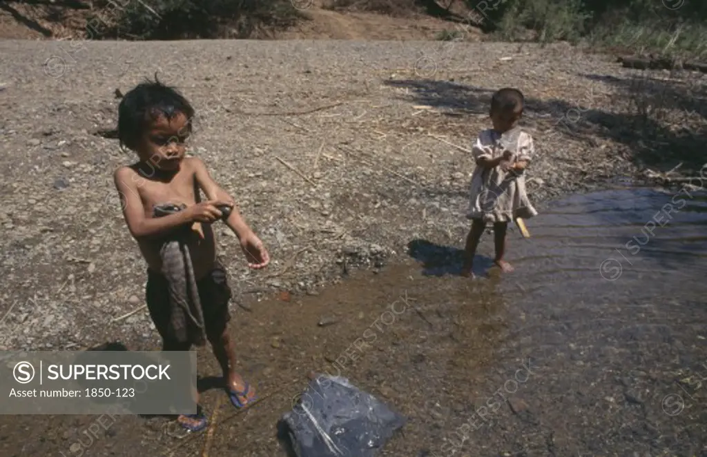 Thailand, North, Mae Sariang, Two Young Karen Refugee Children Washing At The Waters Edge