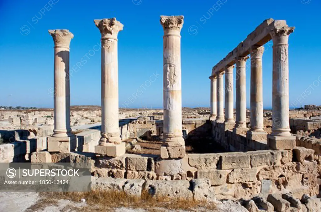 Libya, Tripolitania, Sabratha, Roman Forum.  Standing Columns And Ruined Walls And Streets.