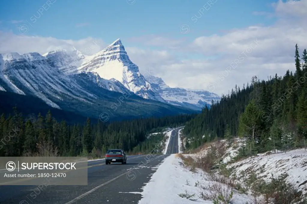 Canada, Alberta, Banff National Park , Car On Trans-Canada Highway Through Snow Covered Landscape.
