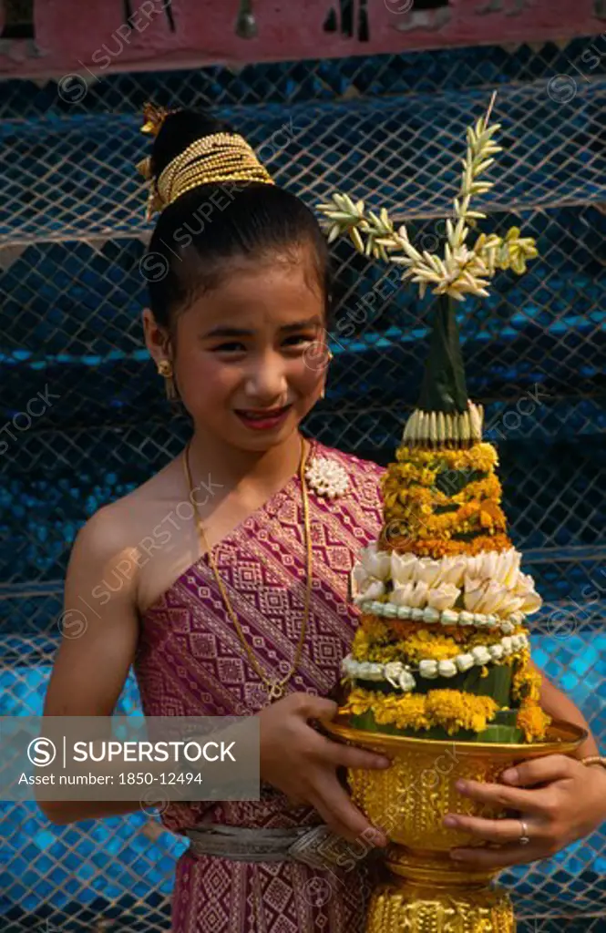Laos, Luang Prabang, Young Girl In Traditional Dress With Flower Offering At New Year Celebrations.