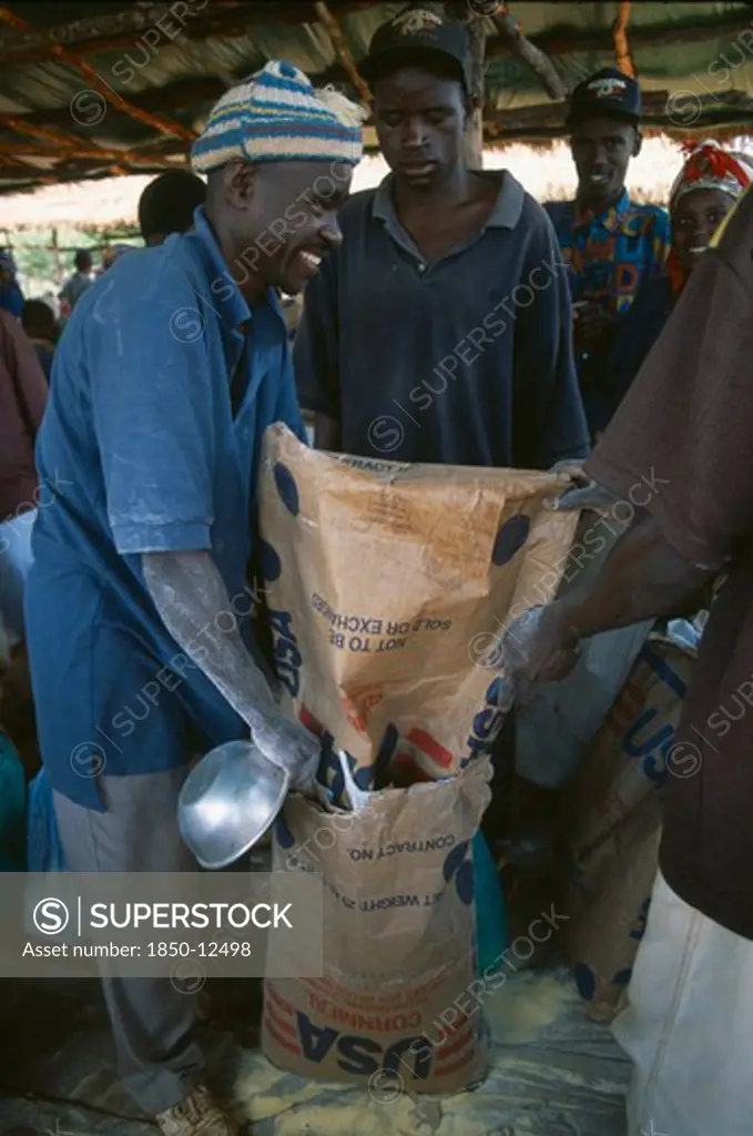Tanzania, West, Great Lakes Region, Mkugwa Refugee Camp.  Distribution Of Food Aid Supplying Cornmeal From The United States Of America.