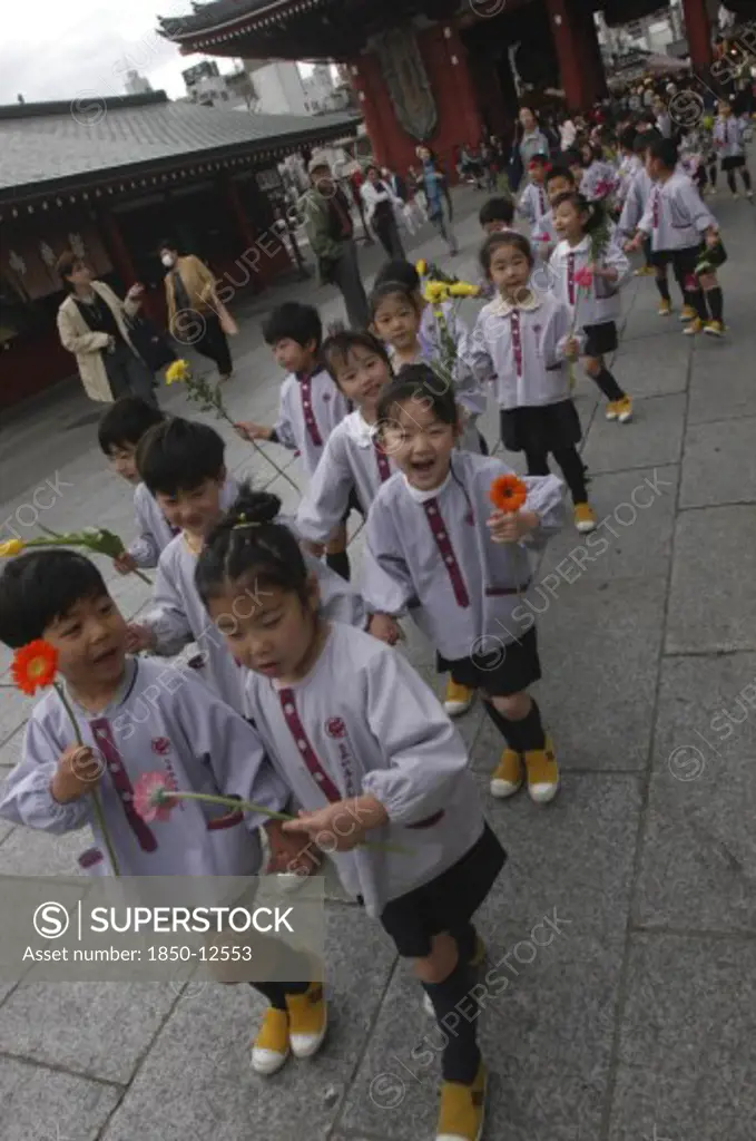 Japan, Honshu, Tokyo, 'Asakusa. 4 Year Old Nursery Students From Senso-Ji Dembo-In Nursery, Carrying Flowers To Present To Buddha As Part Of His Birthday Celebrations, Accopamied By Buddhist Monk'