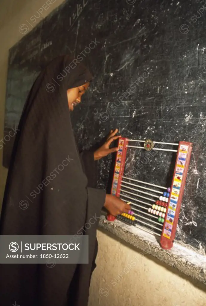 Somaliland, Hargeisa, Ali Osman Primary School.  Girl Using Abacus In Classroom.