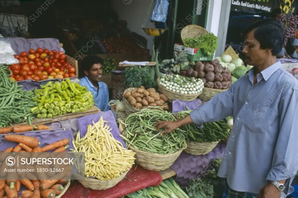 Sri Lanka, Colombo, Pettah District. Customer At A Market Stall Selling Vegetables