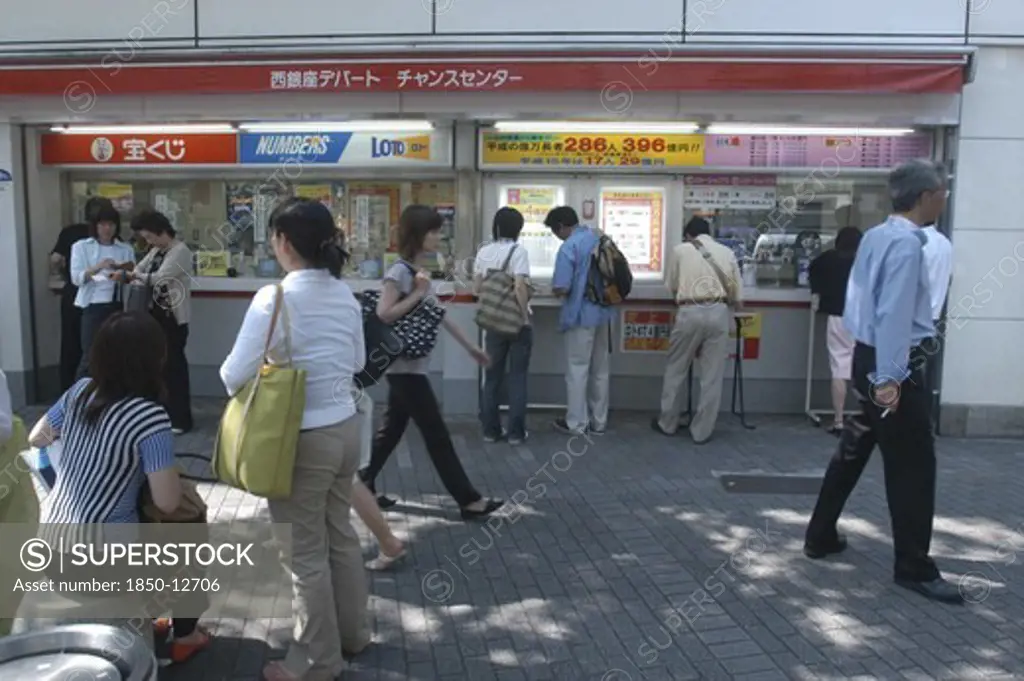Japan, Honshu, Tokyo, Ginza. People Buying Tickets At A Kiosk For A Popular High Stakes Lottery