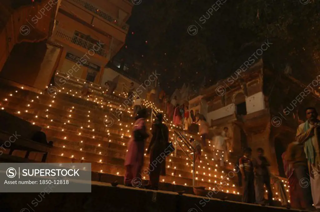 India, Uttar Pradesh, Varanasi, Deep Diwali Festival. View Looking Up Steps Leading Down To The Ganges River With Festival Goers And Oil Lamps