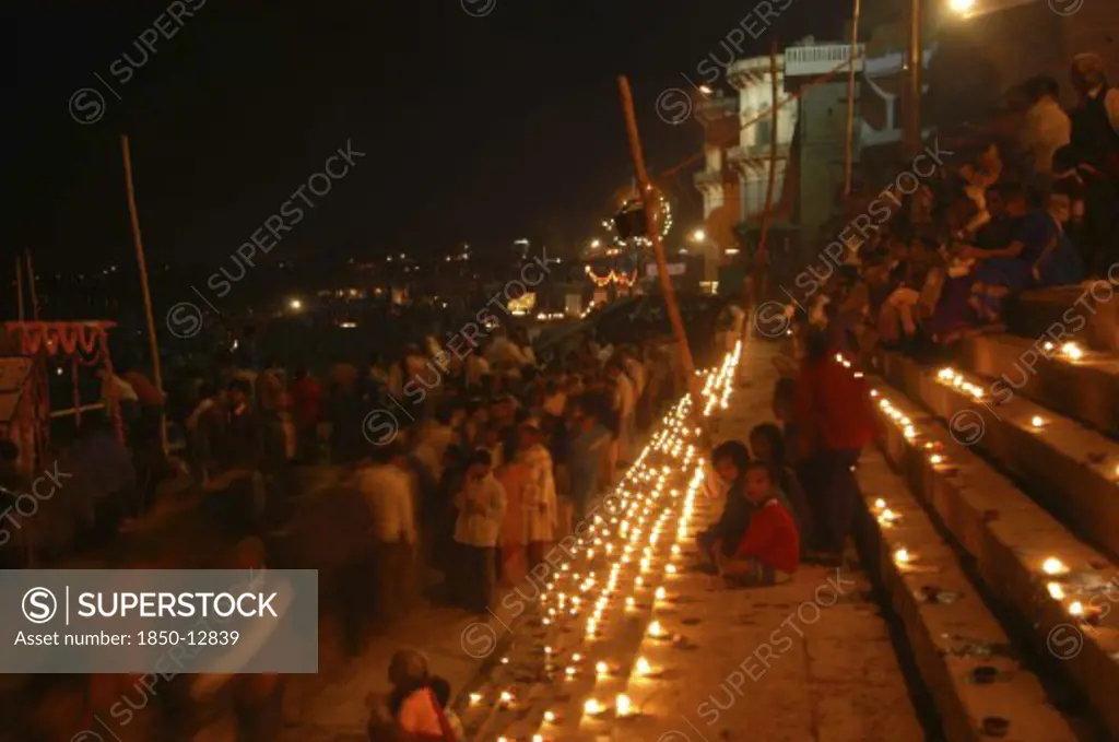 India, Uttar Pradesh, Varanasi, Deep Devali Festival On The Ghats Lining The Ganges River With Festival Goers Lighting Oil Lamps
