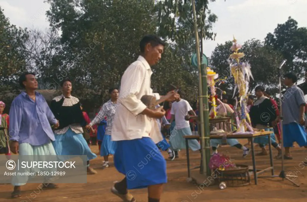 Thailand, Chiang Rai Province, Huai Khrai, Lisu People Dancing Around New Year Tree To A Banjo Player