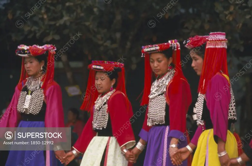 Thailand, Chiang Rai Province, Huai Khrai, Young Lisu Women Dancing In Their New Year Finery
