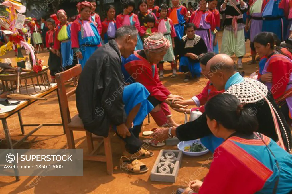 Thailand, Chiang Rai Province, Huai Khrai, New Year. Lisu People Paying Respects To Their Elders By Putting New Socks On Their Feet