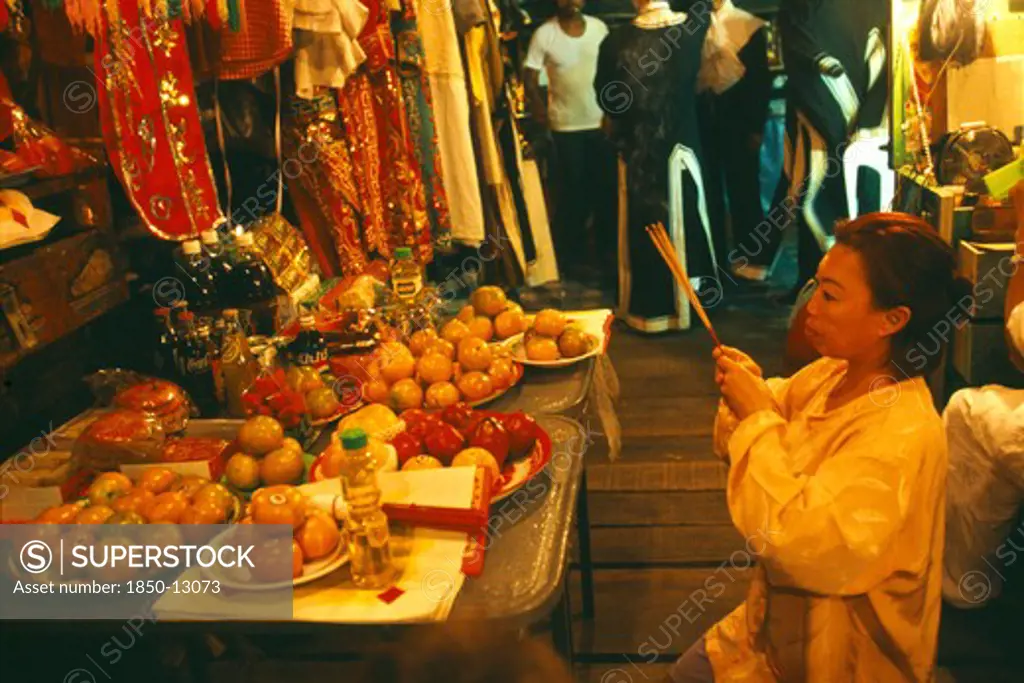 Thailand, Chiang Mai, Female Performer At The Chinese Opera Offering Joss Sticks In Prayer