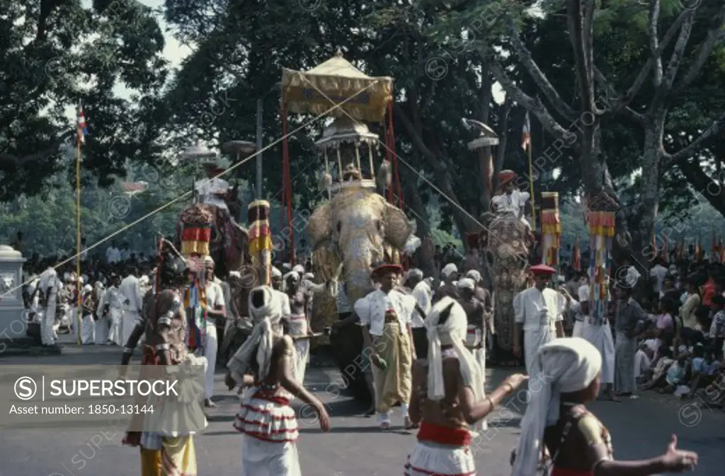 Sri Lanka, Kandy, 'Esala Perahera Festival Parade With Decorated Maligawa Tusker Elephant Carrying Replica Of The Golden Relic Casket, Dancers And Musicians.'