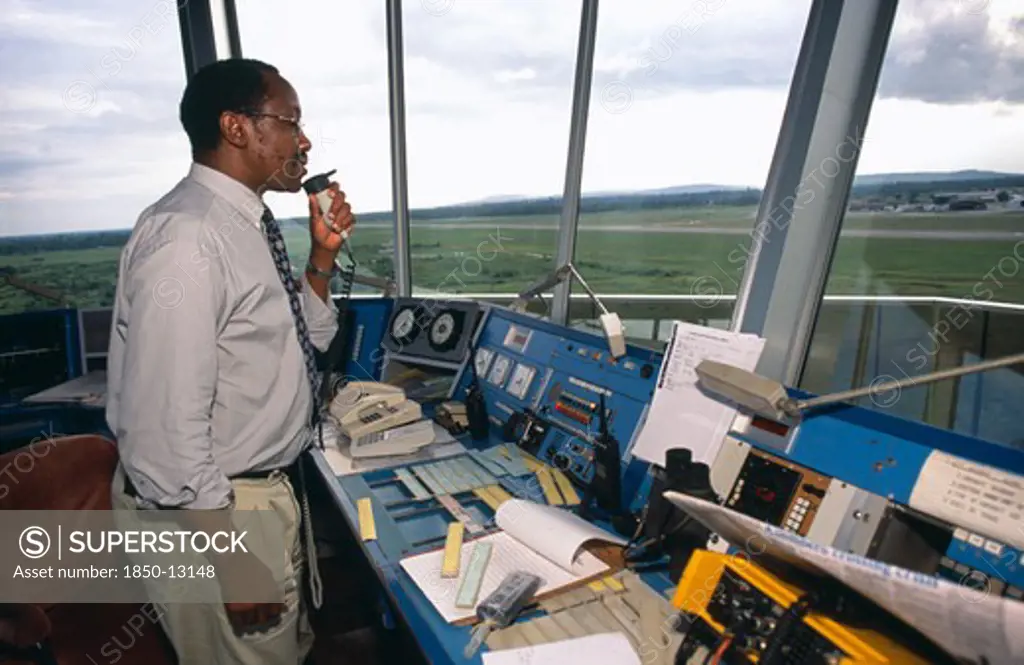 Tanzania, Dar Es Salaam, Man Using Radio In Airport Control Tower In Dar Es Salaam Airport.