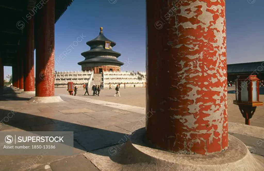 China, Beijing, Temple Of Heaven.  Hall Of Prayer For Good Harvests Through Colonnade Of Pillars With Peeling Red Paint.