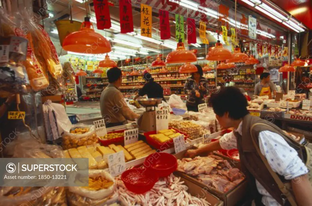 China, Hong Kong, 'Wanchi Market Interior With Display Of Variety Of Food Products, Customers And Staff.'