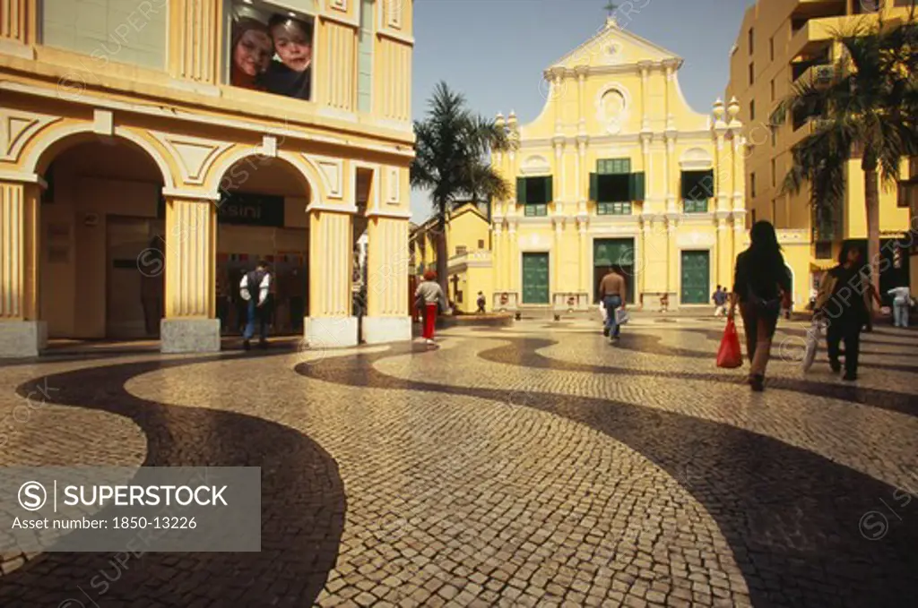 China, Macau, Church Of St Dominic.  Exterior With People Walking Across Mosaic Tiled Area In The Foreground.