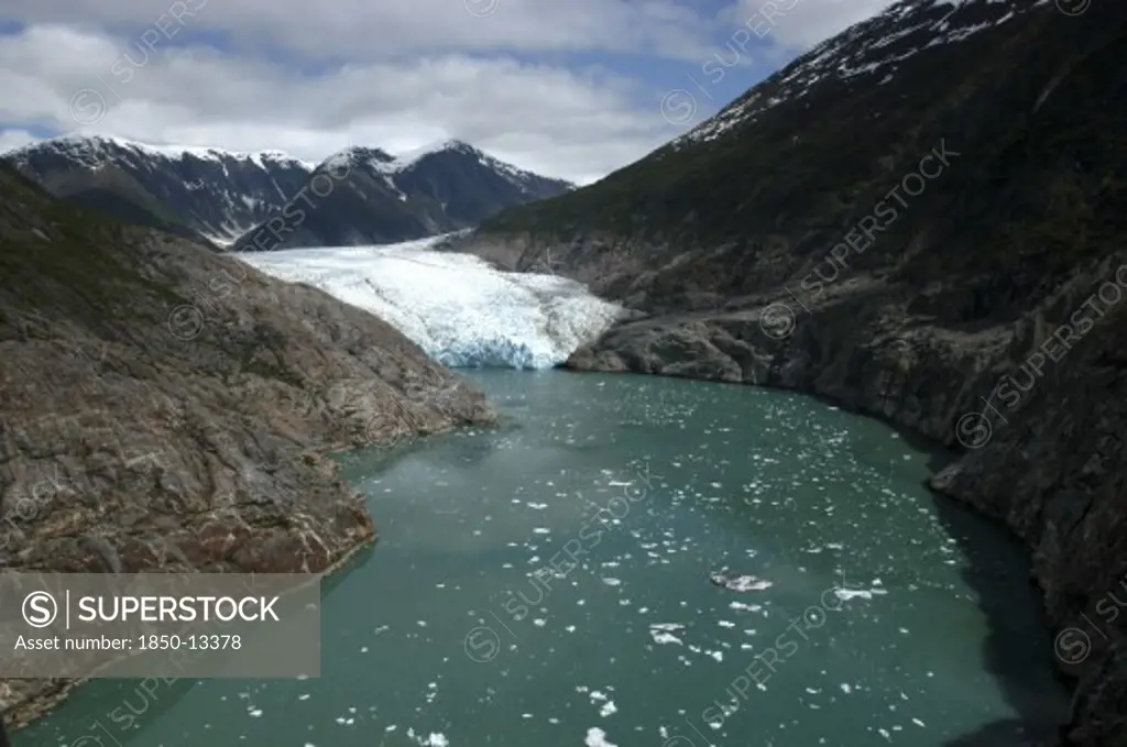 Usa, Alaska, Tracy Arm Fjord, View Along Waterway Toward Icy Slope And Mountain Peaks Beyond