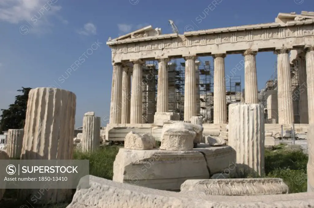 Greece, Athens, Acropolis. View Of The Ruined Parthenon With Smaller Sections Of Columns In The Foreground