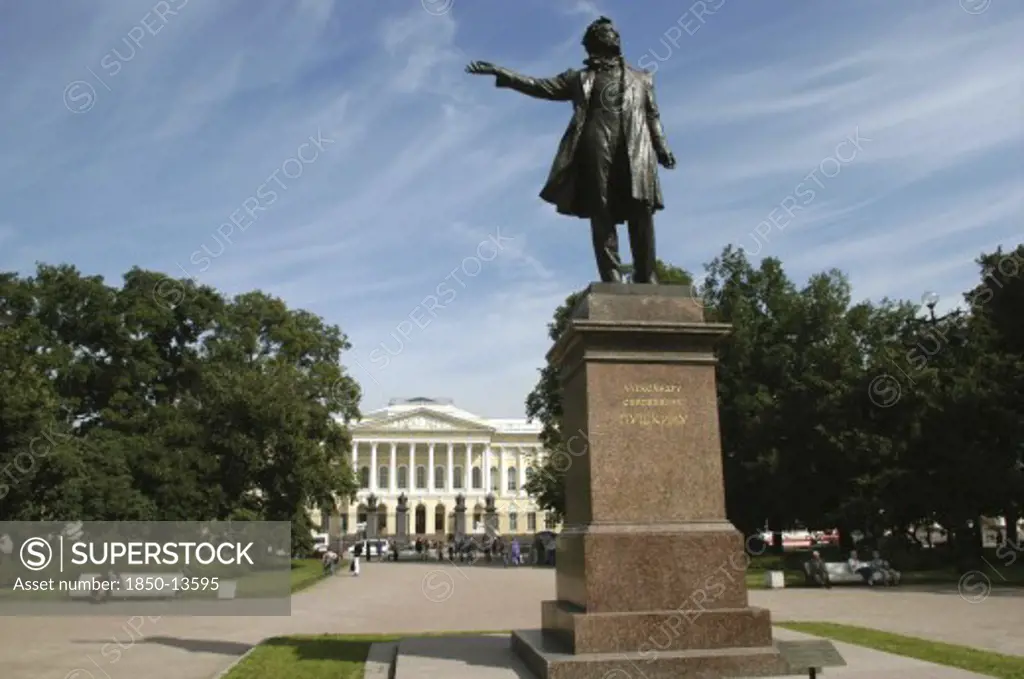 Russia, St Petersburg, Statue In Park With The Mikhailovsky Palace And Russian Museum In The Distance