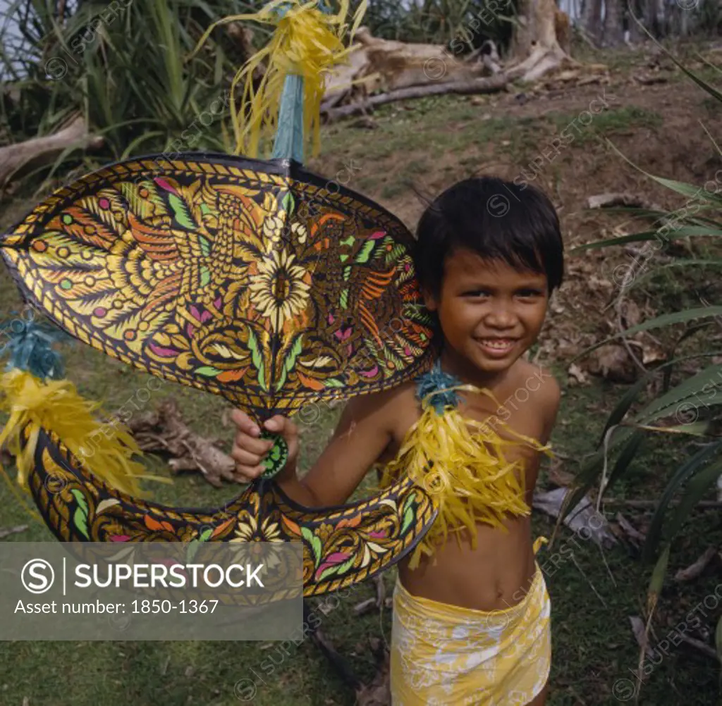 Malaysia, Kelantan, Kota Baharu, Malay Boy Holding Multicoloured Kite