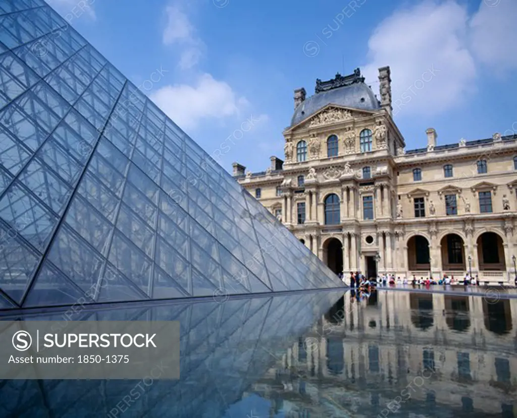 France, Ile De France, Paris, Louvre.  Cour Napoleon And Glass Pyramid Reflected In Water