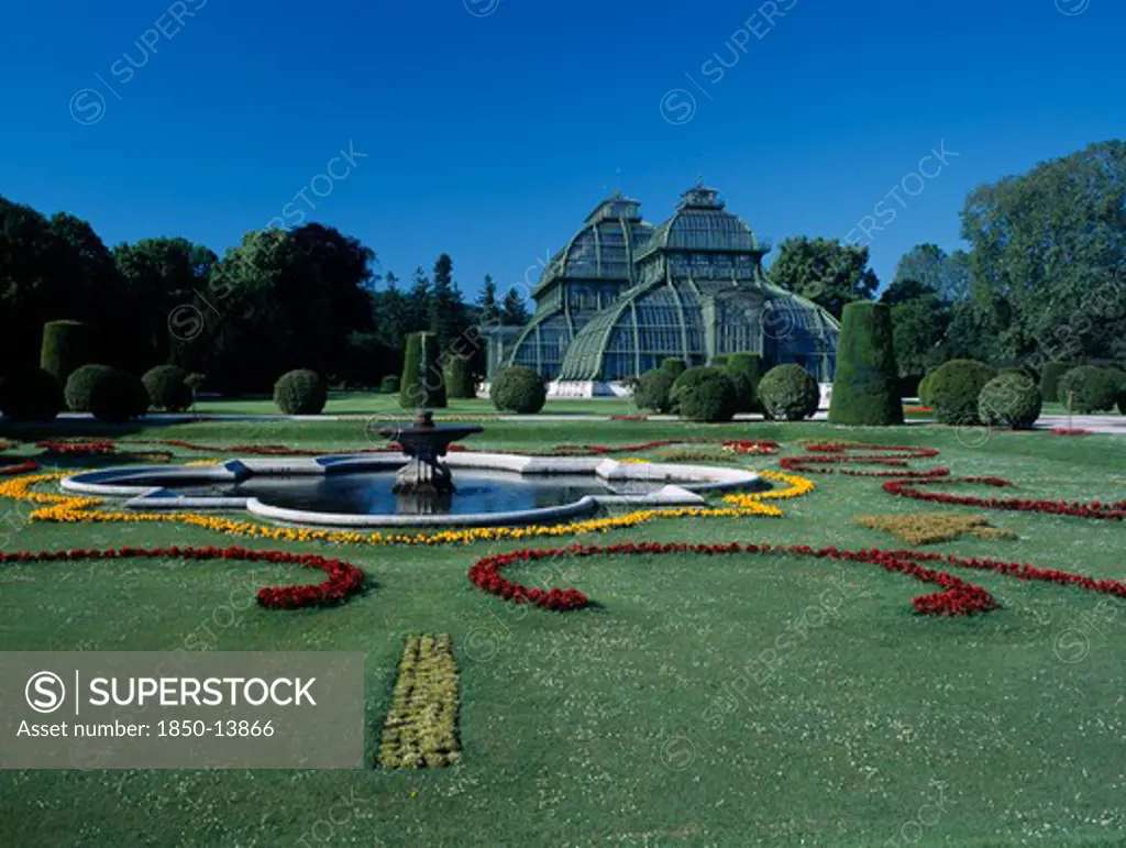 Austria, Vienna, Schonbrunn Palace Formal Gardens With Fountain And The Palm House